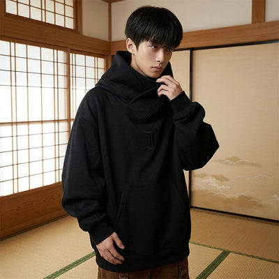 Person wearing a black harajuku hoodie in a traditional Japanese room with shoji screens.