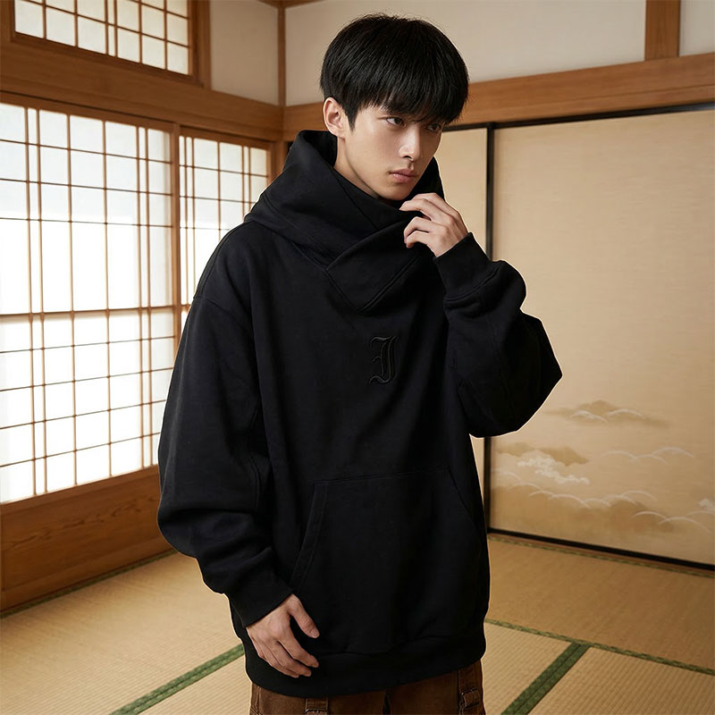 Person wearing a black harajuku hoodie in a traditional Japanese room with shoji screens.