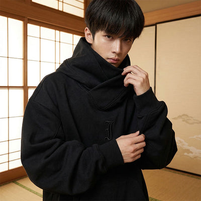 Man wearing a black hoodie japanese in a traditional Japanese room with shoji screens.