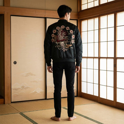 Person wearing a black Raijin jacket with floral embroidery in a traditional Japanese room.