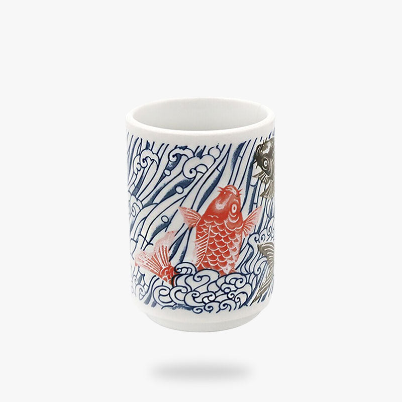 The blue and white Japanese tea cups are adorned with a graceful koi carp motif, representing courage and strength in Japanese culture, elegantly depicted in classic blue and white colors