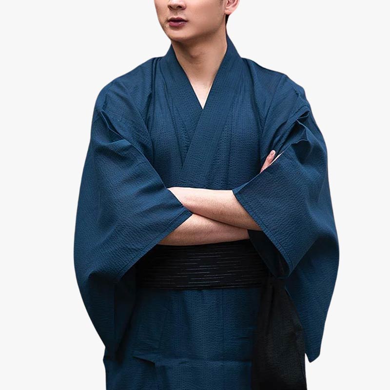 A japanese is dress with dark blue kimono men. Arms are crossed on his japanese black obi belt (kimono belt)