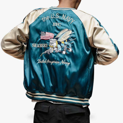 Secure a piece of history when you buy vintage reversible japanese bomber jacket from Okinawa, featuring designs that tell a story of the region.  A man wears a reversible sukajan bomber with a US Army symbol embroidered on the back.