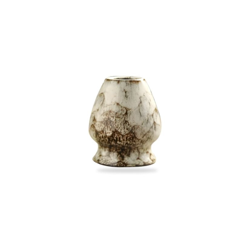 Small ceramic chasen holder with a textured surface on a white background