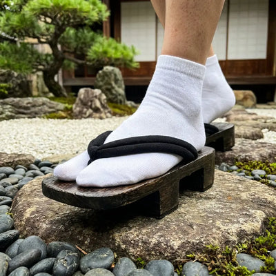 Close-up of thick corded hanao strap on geta Japanese woman sandals