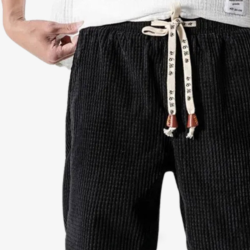 Corduroy black pants featuring classic Japanese-inspired silhouettes and soft corduroy fabric.