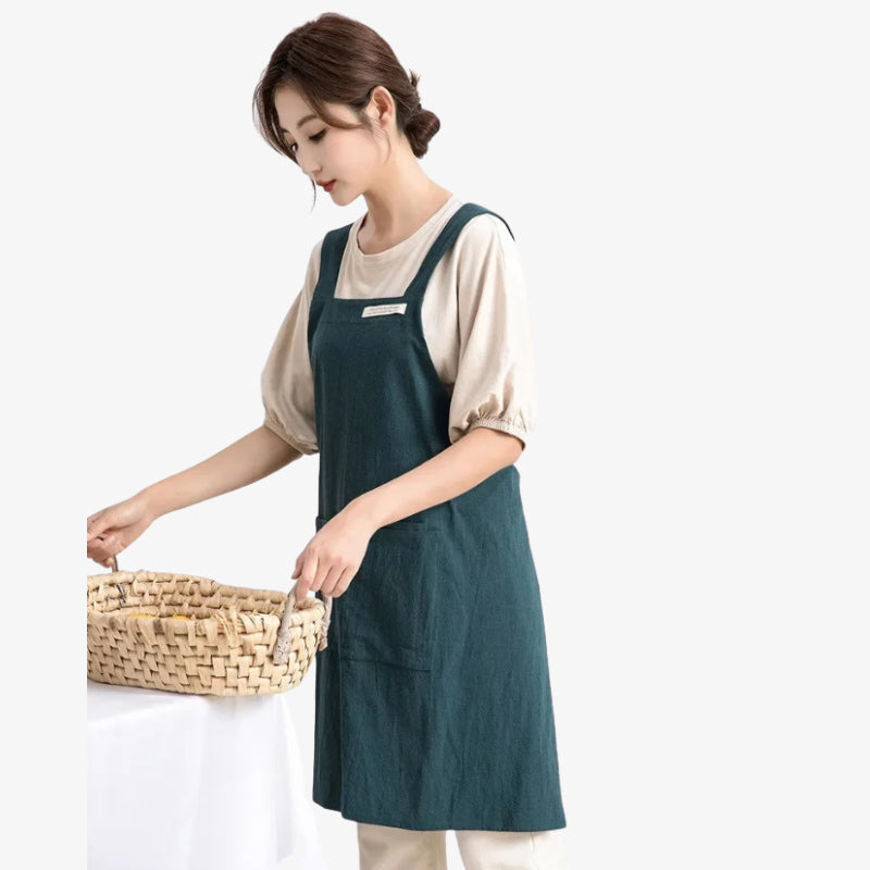 Cross back Japanese apron featuring natural fibers and a secure rear strap system, ideal for extended kitchen wear.