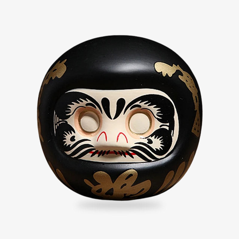 Daruma doll in black, a Japanese charm known for bringing protection and good fortune, ideal for setting and achieving personal goals