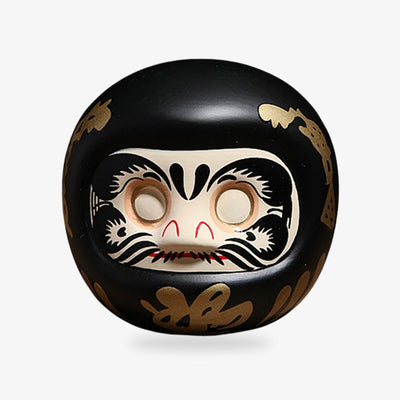 Daruma doll in black, a Japanese charm known for bringing protection and good fortune, ideal for setting and achieving personal goals