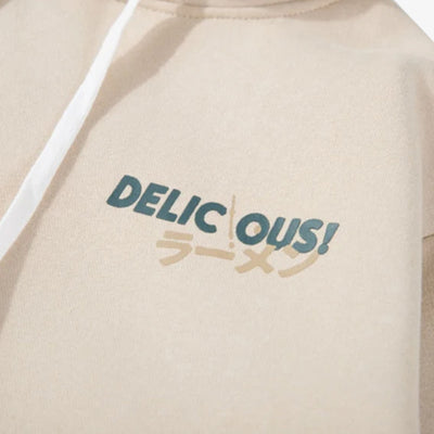 Beige hoodie with 'DELICIOUS!' text and graphic design with japanese Kanji on a plain background