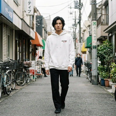 Model moving while wearing the white ramen graphic hoodie with drawstring hood