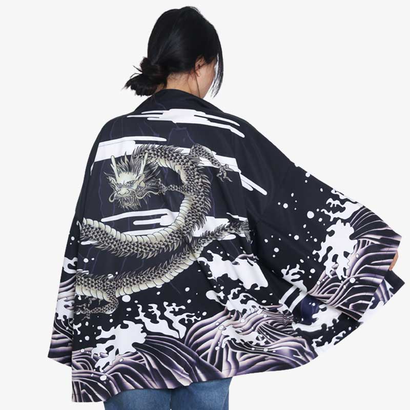 Turn heads with a Dragon Kimono Dress, featuring dramatic dragon patterns and japanese waves design. The women is standing with her black kimono jacket