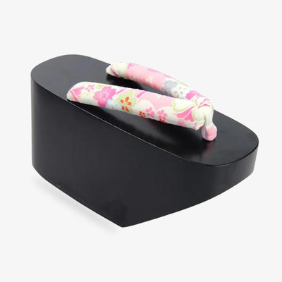 Geisha platform sandalshistorically worn for performing arts and ceremonies. The strap is printed with japanese flower symbols. The wood material is black