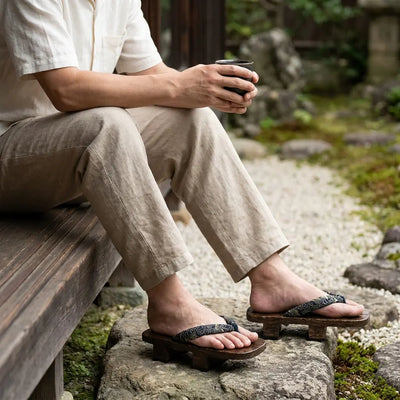 Geta Japan sandals paired with white tabi socks on a stone garden path