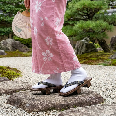 Geta Japan worn with a pink kimono in a Japanese garden