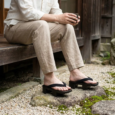 Geta Japanese woman sandals worn with white tabi socks in a Japanese garden