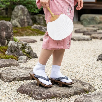 Geta Seigaiha worn with a pink kimono in a Japanese garden