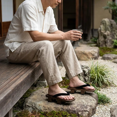 Geta Woman sandals worn with white tabi socks in a Japanese garden