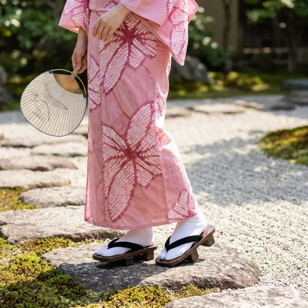 Geta Woman worn with a pink kimono in a Japanese garden