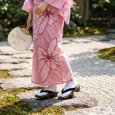Geta Woman worn with a pink kimono in a Japanese garden