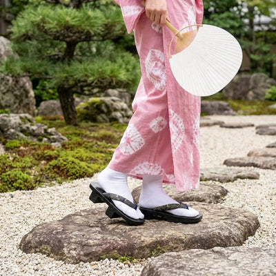 Geta Wood Sandals worn with a pink kimono in a Japanese garden