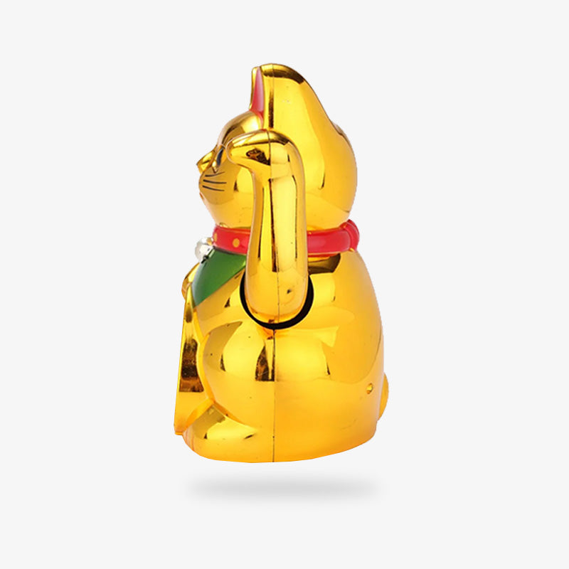A lucky gold fortune maneki neko cat with its left paw raised