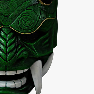 Discover the green Oni mask meaning, a handcrafted piece symbolizing Japanese folklore, made from high-quality materials, painted by hand, with horns and sharp teeth