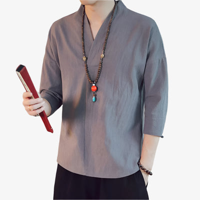 A man wearing a gray Japan shirt mid-length sleeve V-neck style with three-quarter sleeves, made of natural linen.