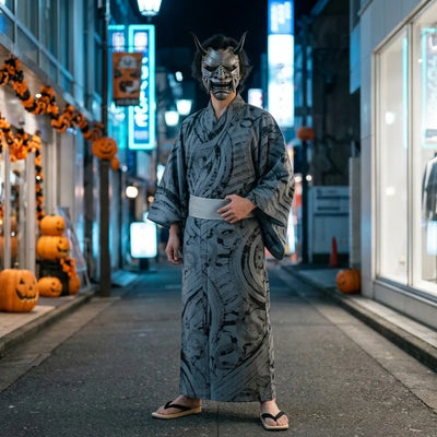 Halloween grey oni mask worn full length with a grey brush-print kimono in an empty Tokyo street at night