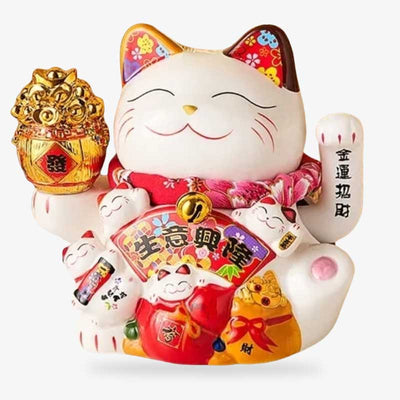 The hand-made maneki-neko lucky cata has its left paw raised.