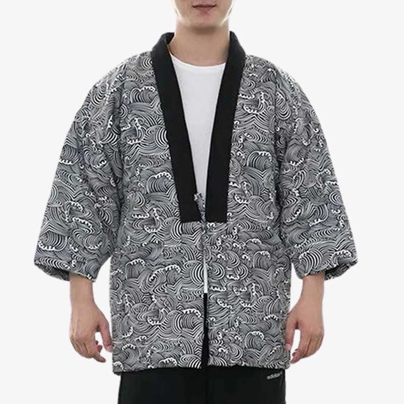 A person wearing a traditional Japanese hanten jacket Men with a geometric black and white pattern.