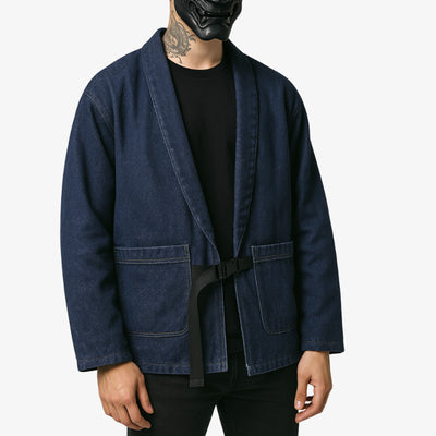Person wearing a blue haori denim jacket with a black belt on a white background