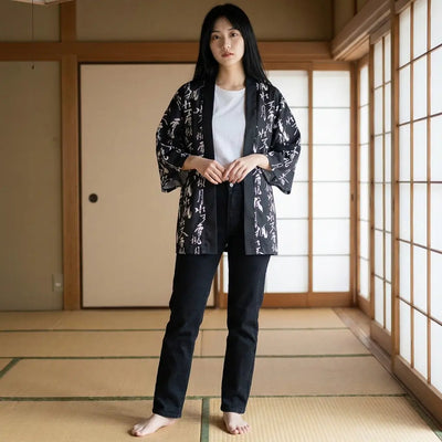 Woman wearing a japanese haori jacket in a washitsu room with tatami and shoji screens