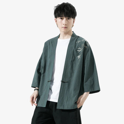 Person wearing a green Haori Kimono Cardigan kimono-style jacket with white embroidery on a white background