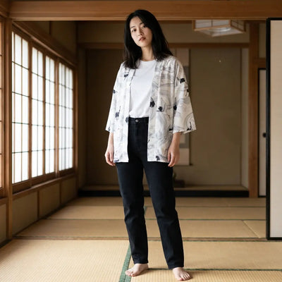 Woman wearing a white haori in a washitsu room with tatami and shoji screens