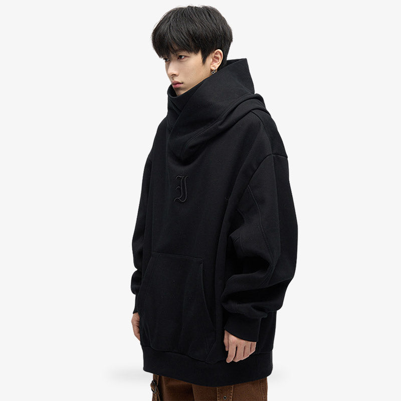 a japanese man is standing and dressed with Harajuku hoodie mens designed with black minimalism color and durable material, ideal for a fashionable and edgy Japanese streetwear look