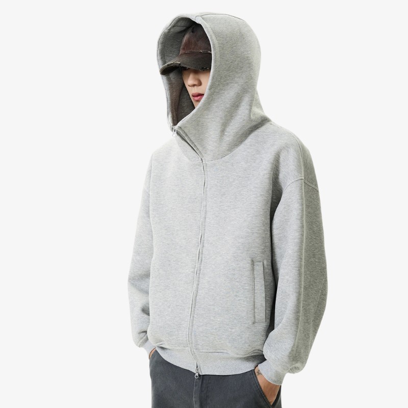 a man is dressed with a fashion Harajuku jacket inspired by Tokyo street fashion, combining minimalist grey color design with Japanese urban culture and a jacket hood with a zipper