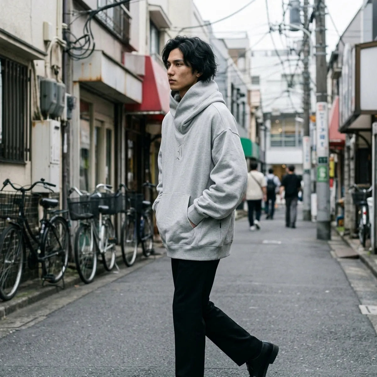 Harajuku streetwear sweatshirt in heather grey, the dropped shoulders and wide sleeves caught mid step