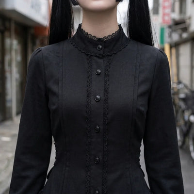 Close view of the stand collar, the black lace edging and the row of buttons on the bodice