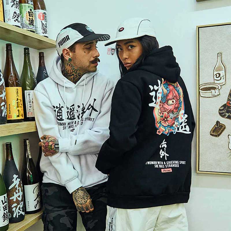 a man and a girl are dressed with black hoodie on and white oni demon hoodie