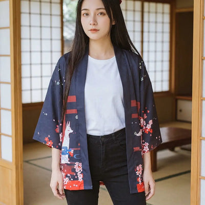 The inari kitsune cardigan seen from the front, a white fox printed on the sleeve.