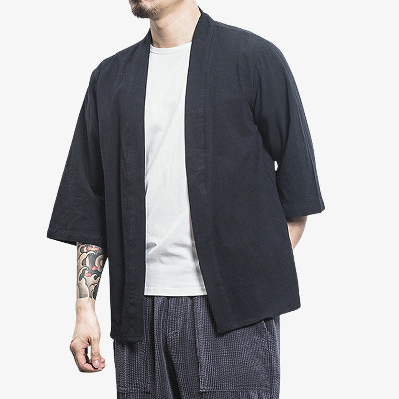 A Japanese man is dressed in a jacket kimono cardigan that is worn loose and open. It is a Japanese man's garment made from linen and cotton. The colour of the haori jacket is black