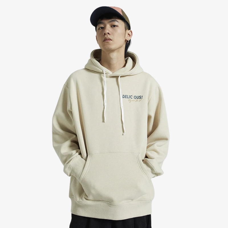Person wearing a beige Japane hoodie Tokyo with text "delicious" and kanji text on a white background