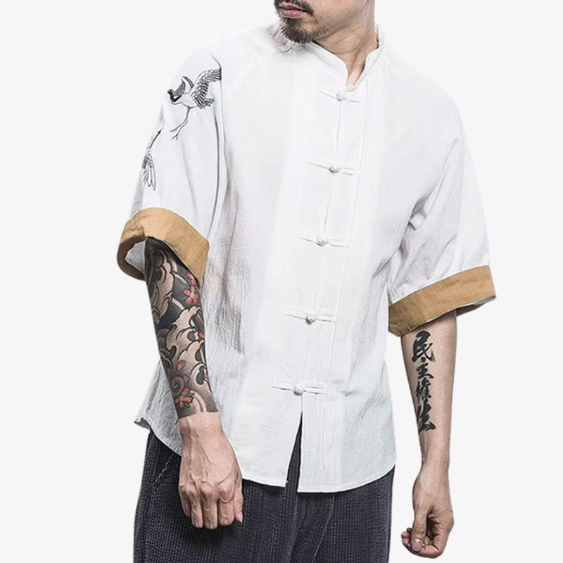A white Japan tee shirt featuring minimalist design and subtle references to Japanese culture with a tsuru bird embroidered on the cotton shoulders shirt. The Japanese shirt for men is deal for a clean and modern streetwear look.