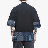 This traditional garment is a japanese black cardigan jacket with wagara motifs printed on the sleeves and the bottom of the haori jacket.