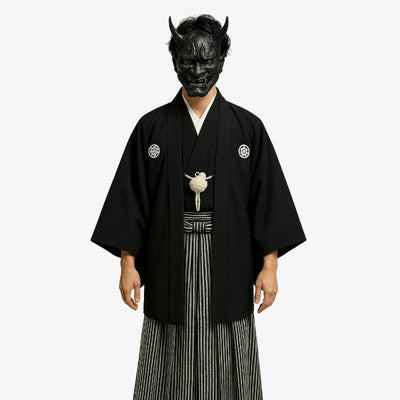 Japanese black kimono made with Habutae silk and adorned with family crests, complemented by a haori jacket and traditional striped hakama trousers.