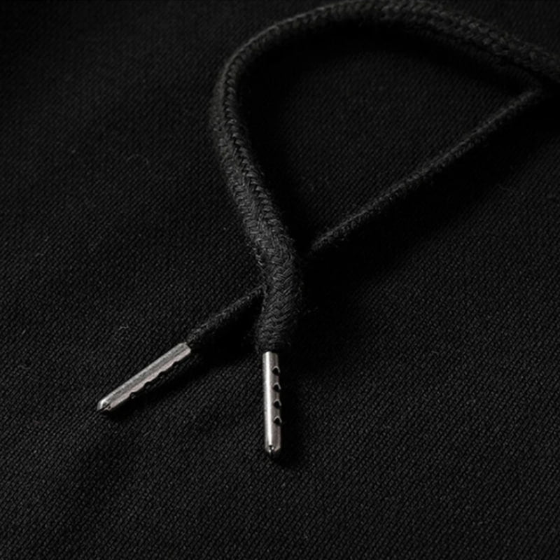 Close-up of japanese black shoelace with metal eyelets on a black background