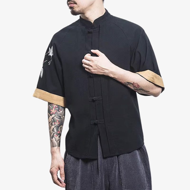a man is dressed with Japanese black t-shirt with refined details and discreet tsuru patterns, balancing simplicity and cultural identity.