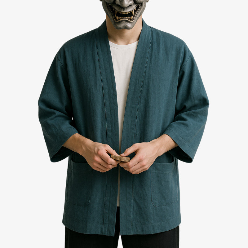 a man is dressed with a Japanese cardigan men style influenced by traditional kimono aesthetics, perfect for refined casual outfits. He wears a white harajuku shirt under the kimono jacket
