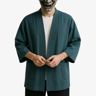 a man is dressed with a Japanese cardigan men style influenced by traditional kimono aesthetics, perfect for refined casual outfits. He wears a white harajuku shirt under the kimono jacket